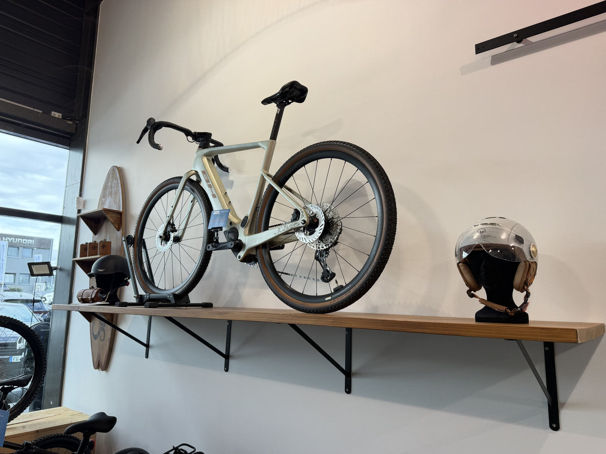 Vélo électrique gravel exposé au mur du magasin E-Bike Caen